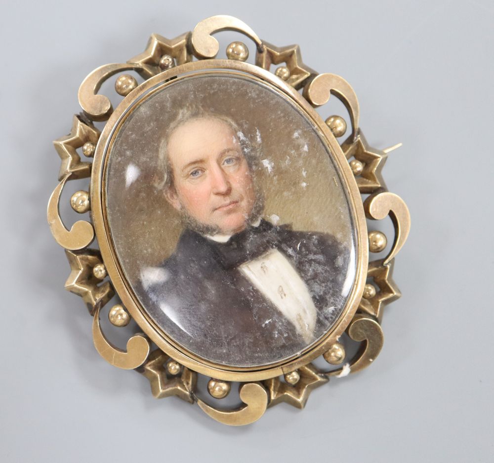 A 19th century yellow metal mounted oval mourning pendant brooch, inset with portrait on a gentleman, 76mm, gross 44,3 grams.